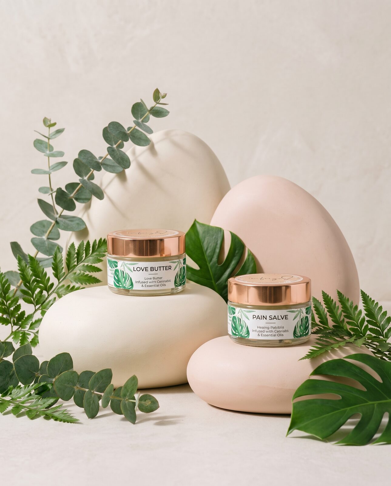Infuzed Love Butter and Pain Salve on blush stone — campaign editorial